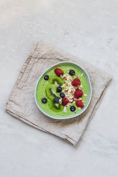 istock Smoothie breakfast bowls with berries, seeds, oats and nuts on white background with copy space 1133318316