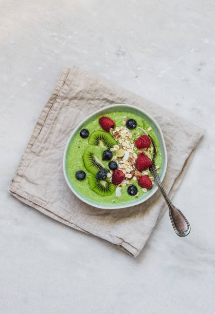istock Smoothie breakfast bowls with berries, seeds, oats and nuts on white background with copy space 1133318540