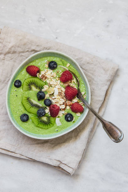 istock Smoothie breakfast bowls with berries, seeds, oats and nuts on white background with copy space 1133318546