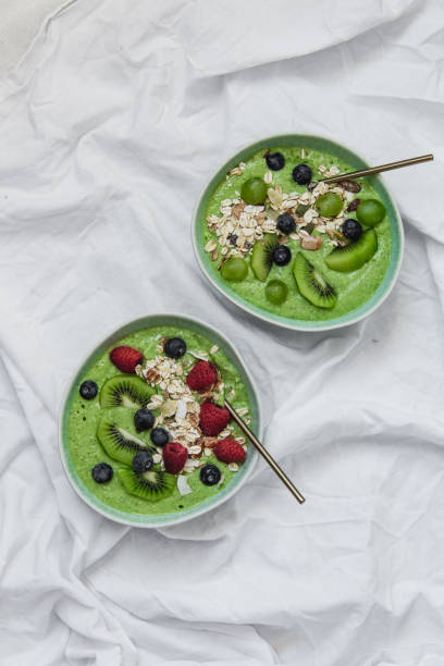 istock Smoothie breakfast bowls with berries, seeds, oats and nuts on white background with copy space 1133318663