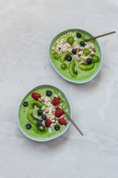 istock Smoothie breakfast bowls with berries, seeds, oats and nuts on white background with copy space 1133318677