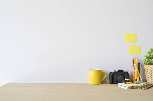 istock Creative workspace camera and office supplies on wood desk with copy space. 1133318744