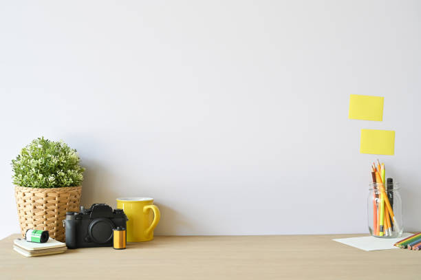 istock Creative workspace camera and office supplies on wood desk with copy space. 1133318745