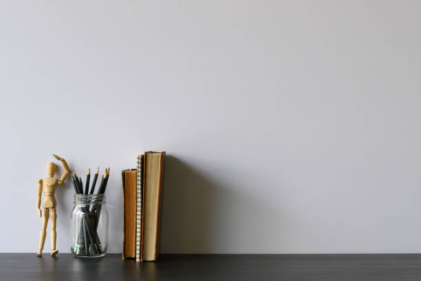 istock Copy space office desk with pencil, books and wood dummy model on table. 1133318818