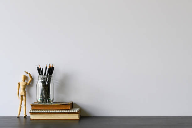 istock Copy space office desk with pencil, books and wood dummy model on table. 1133318843