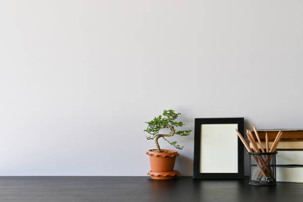 istock Workspace books, pencil, photo frame and bonsai on office desk. 1133318977