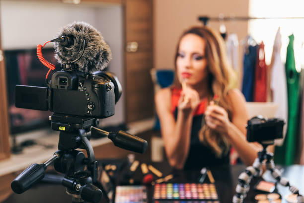 istock Female vlogger making make-up video, focus on foreground 1133324389