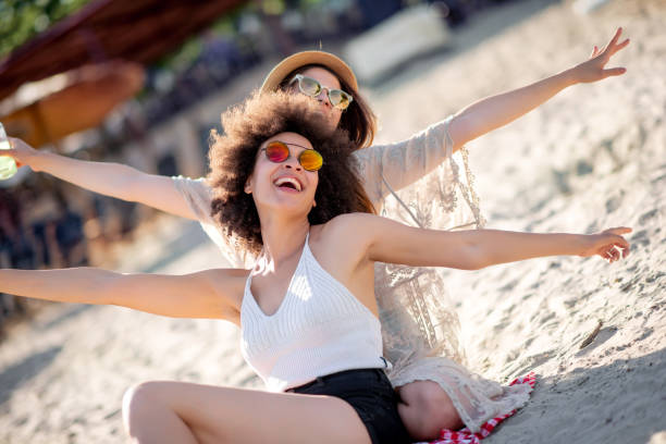 istock Two girls sitting on the beach 1133325649