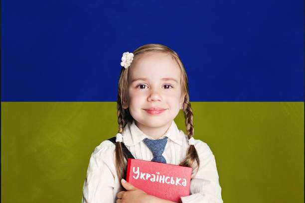 Ukraine concept with kid little girl student with red book on the Ukraine flag background. Learn ukrainian language Ukraine concept with kid little girl student with red book on the Ukraine flag background. Learn ukrainian language ukrainian language stock pictures, royalty-free photos & images