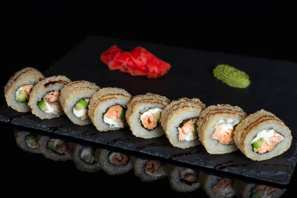 istock Set of sushi rolls on black background 1133328731