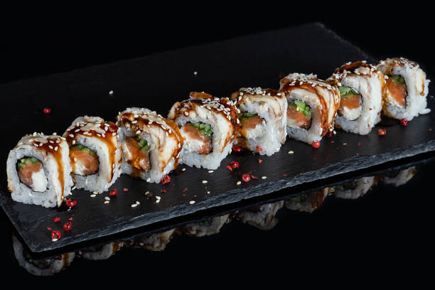 istock Set of sushi rolls on black stone desk background 1133328745