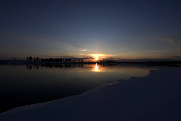 sunset of a sun above the river in the spring