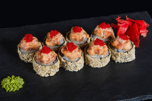 istock Set of sushi rolls on black background 1133328981