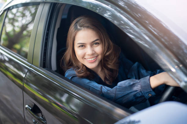 istock Beautiful woman is driving her car 1133330232