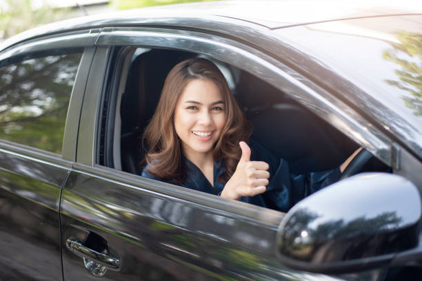 istock Beautiful woman is driving her car 1133330237