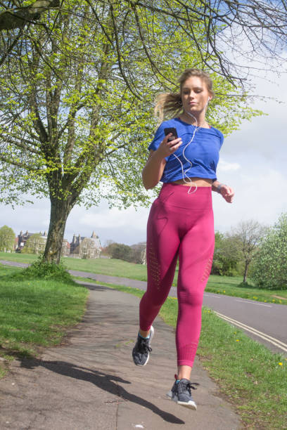 istock Young woman jogging in the park 1133330665