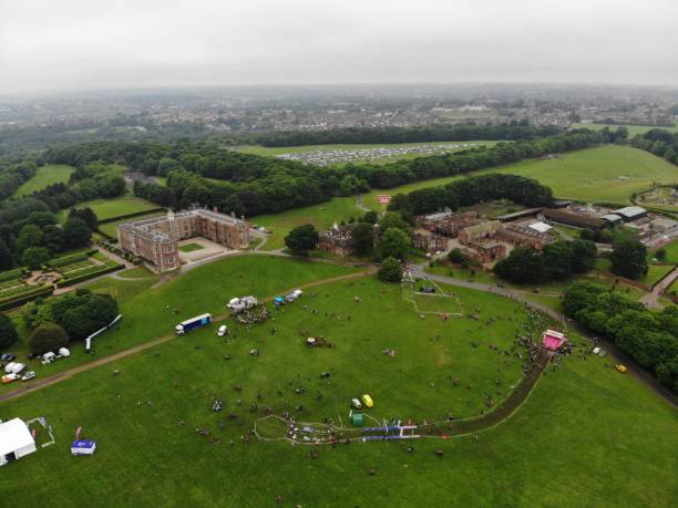 Temple Newsam, Leeds, UK - 2nd June 2018: Aerial photo of the Race for Life Pretty Muddy event Temple Newsam, Leeds, UK - 2nd June 2018: Aerial photos of the Race for Life Pretty Muddy event at temple Newsam, footage showing racers getting muddy outside. temple newsam stock pictures, royalty-free photos & images