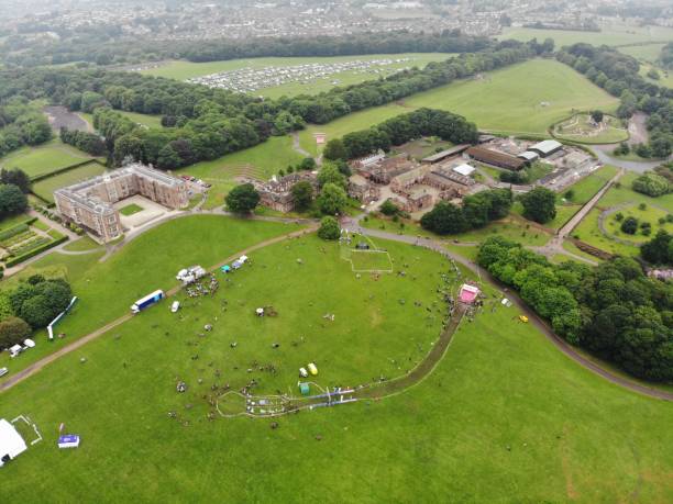 Temple Newsam, Leeds, UK - 2nd June 2018: Aerial photo of the Race for Life Pretty Muddy event Temple Newsam, Leeds, UK - 2nd June 2018: Aerial photos of the Race for Life Pretty Muddy event at temple Newsam, footage showing racers getting muddy outside. temple newsam stock pictures, royalty-free photos & images