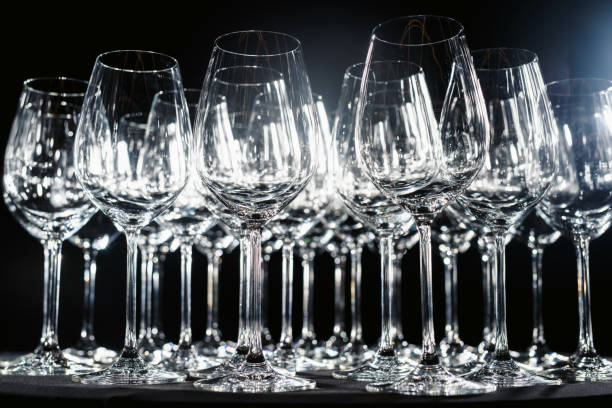 istock Wine glasses stand side by side on a black background isolated with beautiful highlights close-up 1133331855