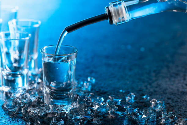 istock Vodka poured into a glass lit with blue backlight. 1133332042