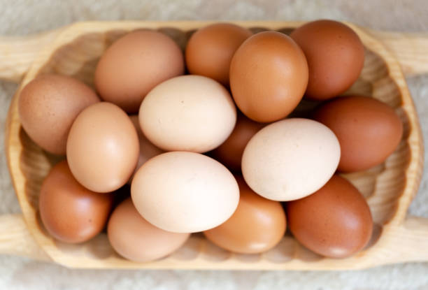 istock Plain multicoloured free range eggs in natural daylight on woode plate 1133335807