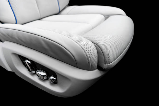 istock White leather interior of a car. Perforated white leather comfortable seats with stitching isolated on black background. Car interior details. Car detailing. Car inside 1133336126