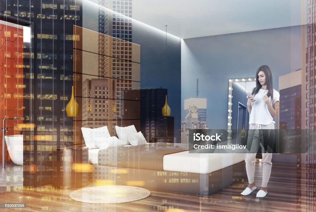 Gray bedroom corner with mirror, woman Woman in corner of bedroom with gray walls, wooden floor, gray master bed with round bedside tables and mirror with ligth bulbs. Toned image double exposure Adult Stock Photo