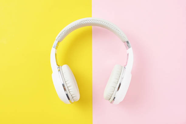 istock White wireless headphones on a pink and yellow background 1133338092