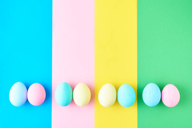 istock Eggs on colored striped background, top view, minimalism concept 1133338100