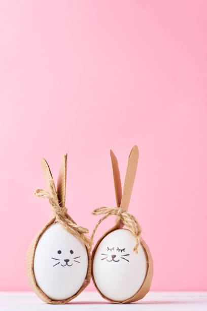 istock Funny homemade eggs with faces on a pink background. Easter concept 1133338113