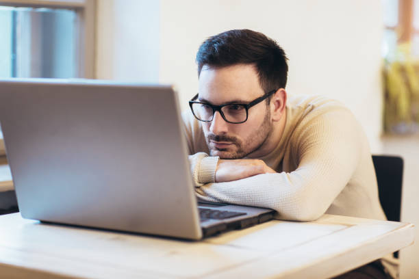istock Man stressed while working on laptop. Upset disappointed young businessman sitting at workplace with hands on head. 1133340128