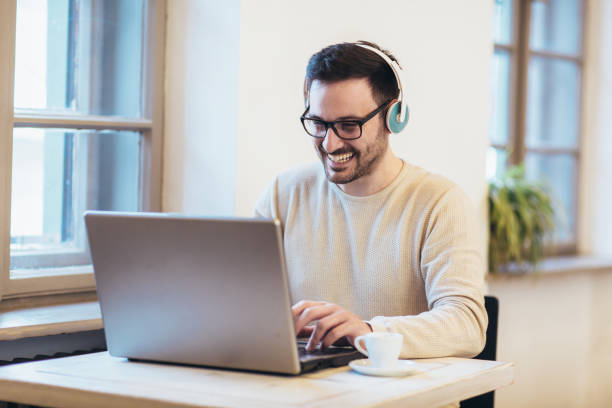 istock Man in front of laptop computer with headset 1133341232