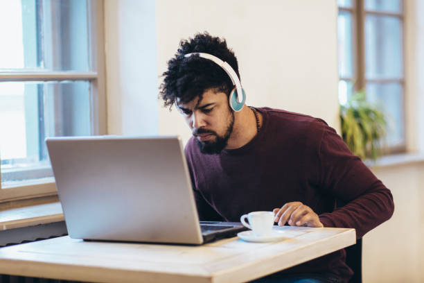 istock Man in front of laptop computer with headset 1133341964