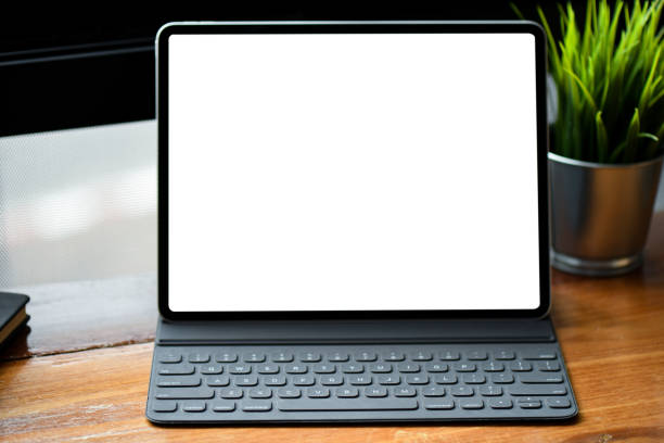 istock Mockup white screen tablet on a wood workspace desk. 1133343690
