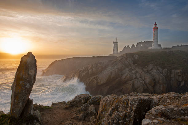 istock Lighthouse Pointe de Saint-Mathieu, sunset big waves, Brittany (Bretagne), France 1133347408