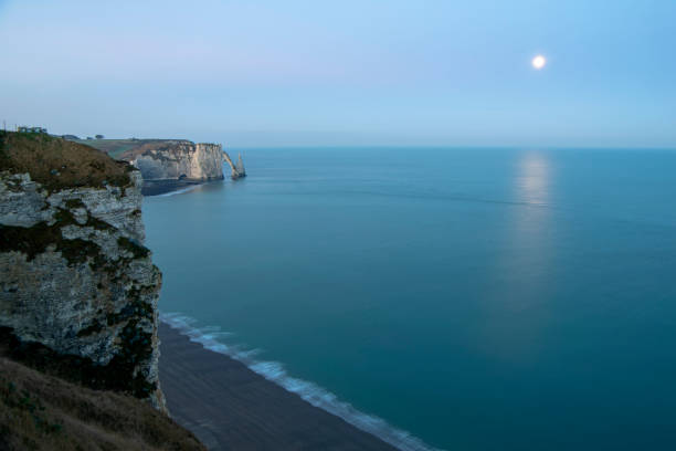 istock Etretat cliffs natural arch with moon , horizontal , Normandy , France 1133350175