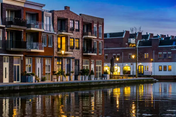 Photo of Dutch houses at the canal by night, City architecture of Alphen aan den Rijn, the Netherlands