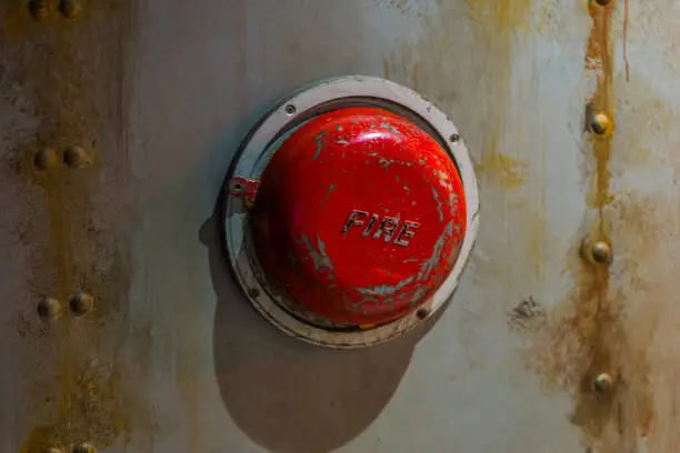 Photo of Old alarm systems, Classic vintage fire alarm bell on the wall of a submarine