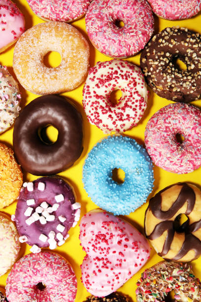 istock assorted donuts with chocolate frosted, pink glazed and sprinkles donuts 1133352497