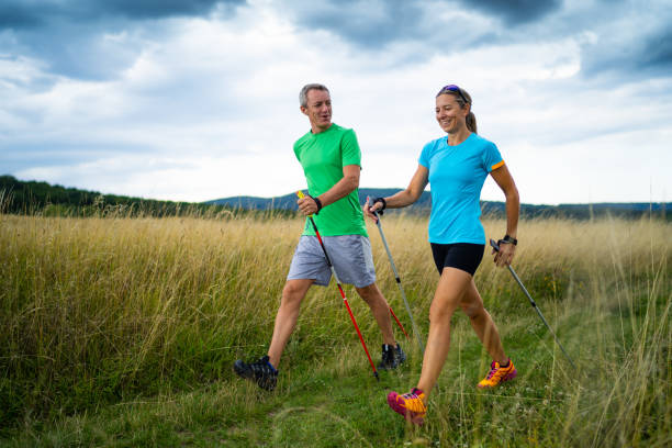 istock nordic walking couple in grassland 1133352834