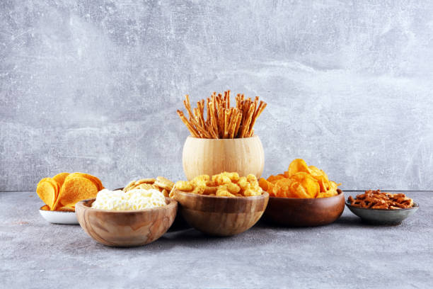 istock Salty snacks. Pretzels, chips, crackers in wooden bowls. 1133352932