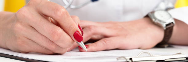 istock Female doctor arm hold silver pen and pad 1133353486