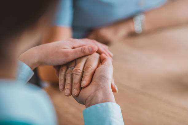 istock Woman holding senior woman's hand 1133353621