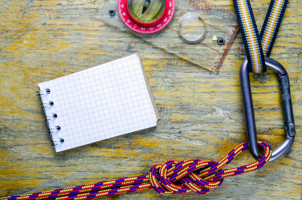 istock Tourist gear and notebook on wood table 1133353829