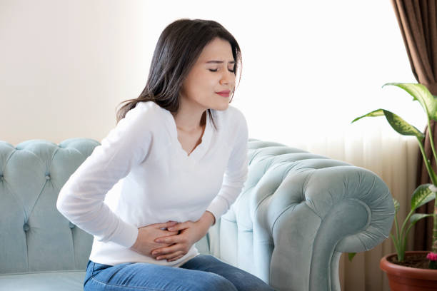 istock Young woman with stomach pain 1133354975