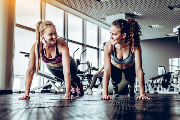 istock Two sporty girls doing push ups. 1133358024