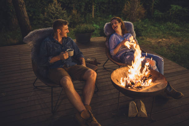 fireplace at porch and summer night - forest sitting men comfortable imagens e fotografias de stock