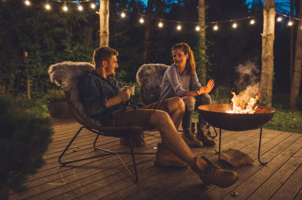 fireplace at porch and summer night - forest sitting men comfortable imagens e fotografias de stock