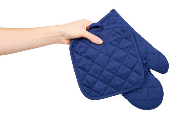 istock Hand with blue kitchen glove, heat protection and safety. 1133362122