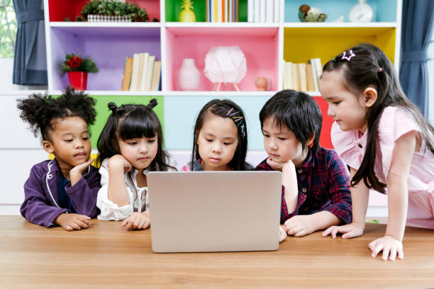 istock children watching film together on laptop 1133363632